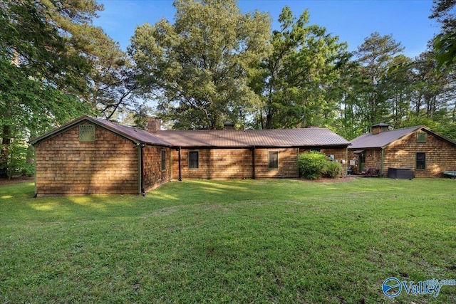 10161 US Highway 11, Springville, AL 35146 - view of front of home with a chimney, a front yard, cooling unit, and metal roof