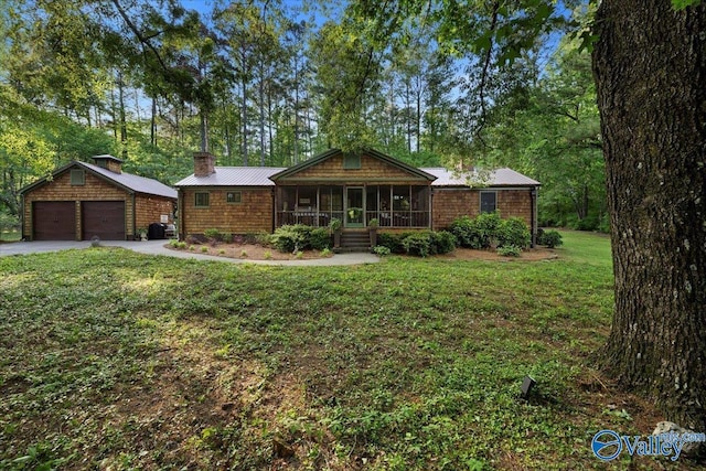 10161 US Highway 11, Springville, AL 35146 - ranch-style house featuring an outbuilding, covered porch, a detached garage, a front yard, and metal roof