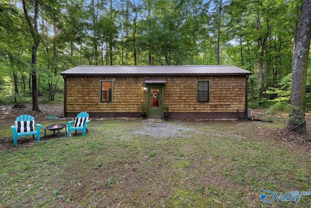 10161 US Highway 11, Springville, AL 35146 - rear view of house featuring an outdoor fire pit and metal roof