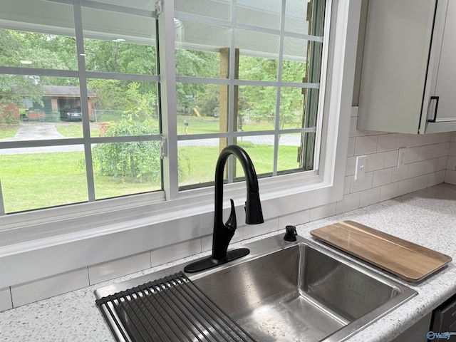 403 SW Arcadia St, Hartselle, AL 35640 - kitchen view of a sink, decorative backsplash, light countertops, and gray cabinetry