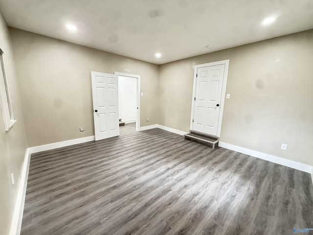 403 SW Arcadia St, Hartselle, AL 35640 - empty room with dark wood-style flooring, baseboards, and recessed lighting
