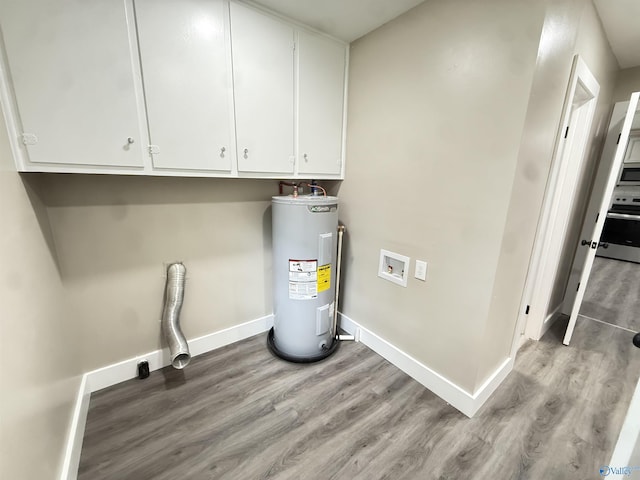 403 SW Arcadia St, Hartselle, AL 35640 - laundry area featuring water heater, light wood-type flooring, baseboards, washer hookup, and cabinet space