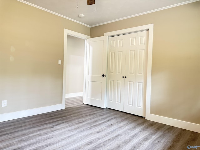 403 SW Arcadia St, Hartselle, AL 35640 - unfurnished bedroom with wood finished floors, baseboards, ornamental molding, and a closet