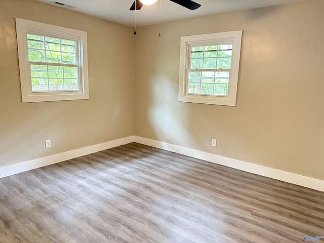 403 SW Arcadia St, Hartselle, AL 35640 - empty room featuring baseboards, wood finished floors, and a ceiling fan
