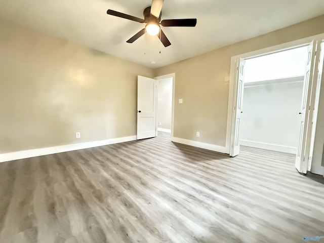 403 SW Arcadia St, Hartselle, AL 35640 - unfurnished bedroom with baseboards, wood finished floors, ceiling fan, and a closet