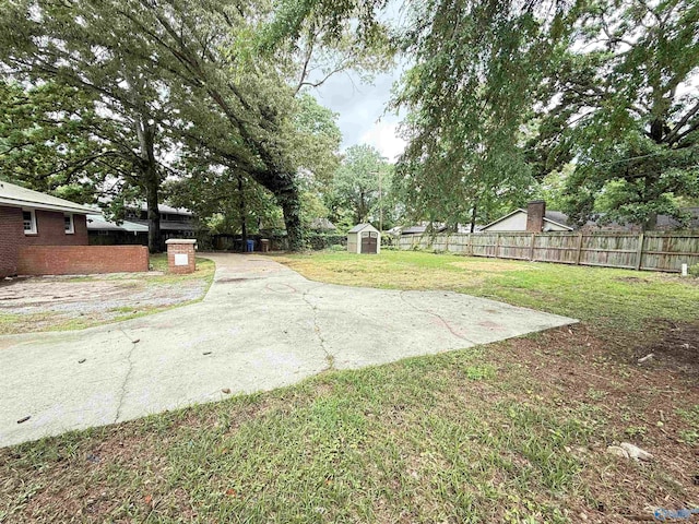 403 SW Arcadia St, Hartselle, AL 35640 - view of yard featuring a storage unit, an outdoor structure, and a patio area
