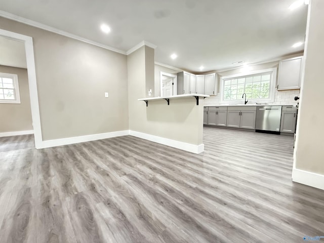 403 SW Arcadia St, Hartselle, AL 35640 - kitchen featuring dishwasher, a kitchen bar, ornamental molding, baseboards, and a sink