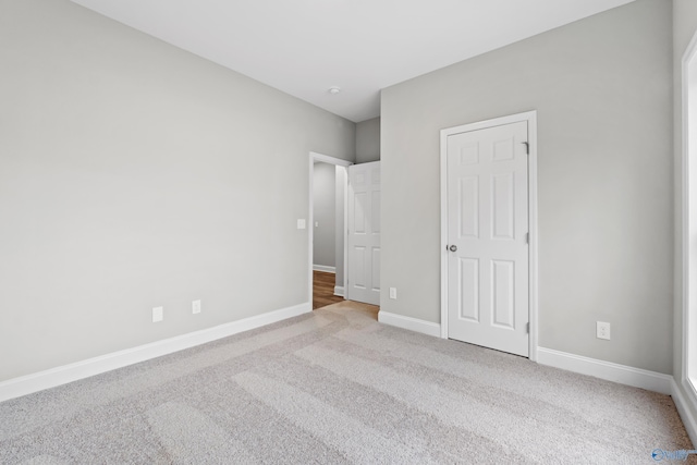 unfurnished bedroom featuring light colored carpet