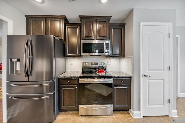 kitchen with light stone counters, dark brown cabinetry, and appliances with stainless steel finishes