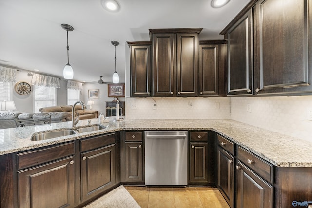 kitchen featuring dark brown cabinetry, sink, decorative light fixtures, and stainless steel dishwasher