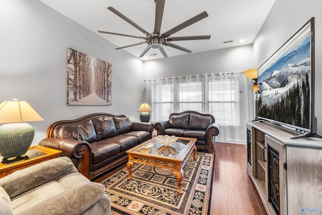 living room featuring dark hardwood / wood-style floors and ceiling fan