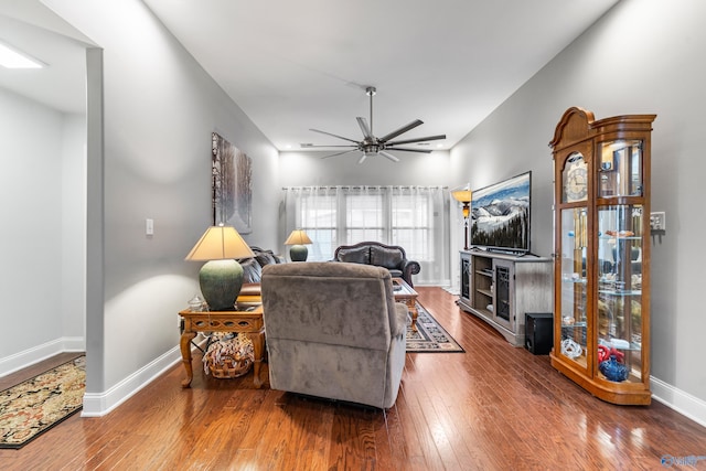 living room featuring wood-type flooring and ceiling fan