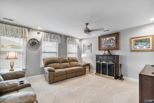 living room featuring light colored carpet and ceiling fan