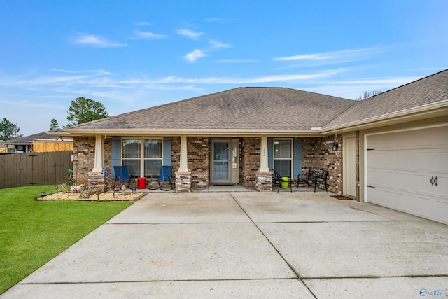 ranch-style house with a garage, covered porch, and a front lawn