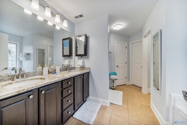 bathroom with tile patterned floors and vanity