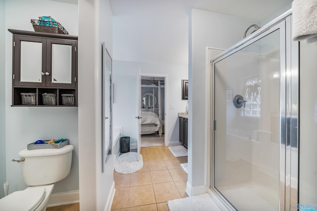 bathroom with tile patterned flooring, vanity, toilet, and walk in shower