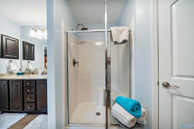 bathroom with walk in shower and vanity