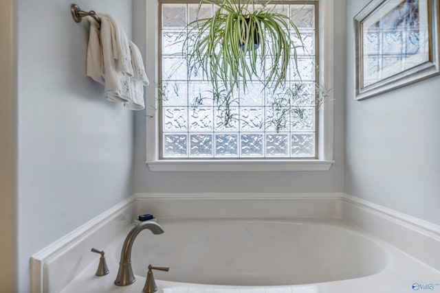 bathroom with a washtub and a wealth of natural light