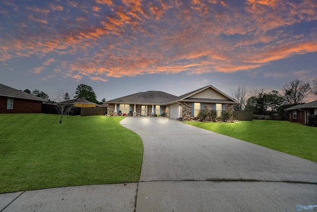 view of front of house featuring a garage and a yard