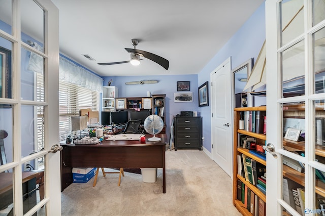 office featuring french doors, ceiling fan, and light carpet