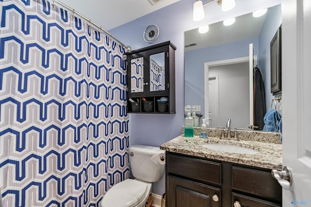 bathroom featuring vanity, a shower with shower curtain, and toilet