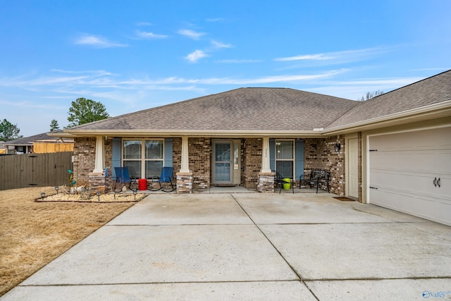 ranch-style home featuring a porch and a garage