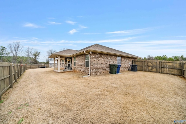 rear view of house with a patio and central AC