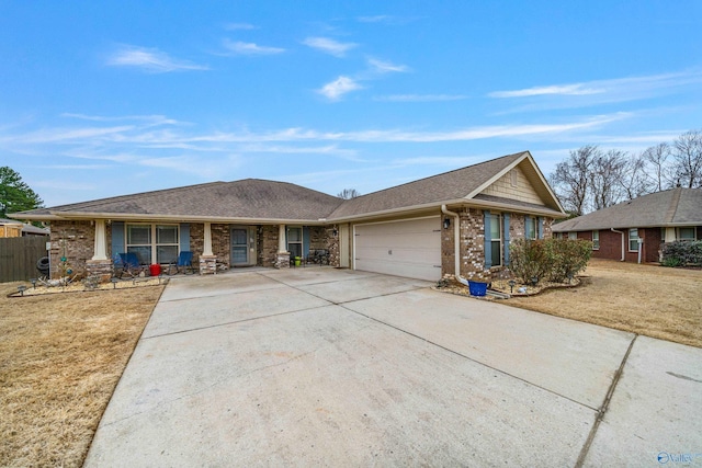 ranch-style home with a garage, covered porch, and a front lawn