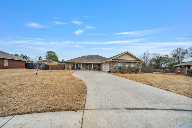 ranch-style house featuring a garage and a front yard