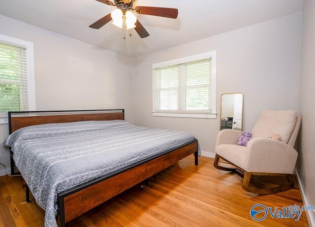 152 6th St W, Grant, AL 35747 - bedroom featuring multiple windows, wood finished floors, baseboards, and a ceiling fan