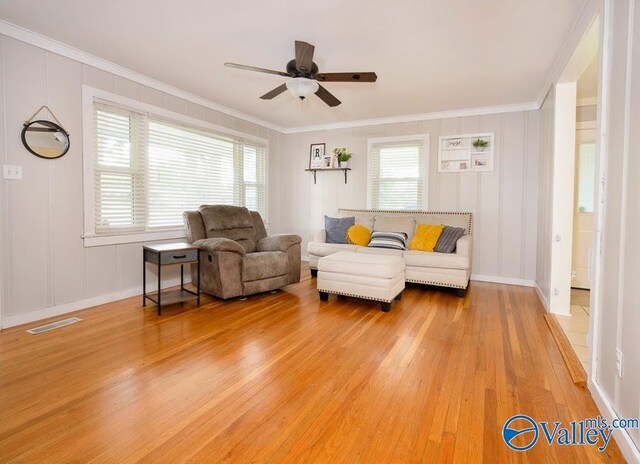 152 6th St W, Grant, AL 35747 - living area with light wood finished floors, ceiling fan, crown molding, a decorative wall, and baseboards
