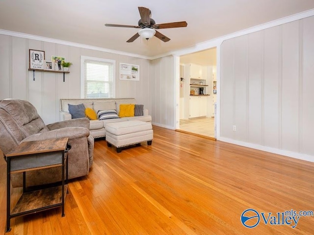 152 6th St W, Grant, AL 35747 - living room with light wood-style floors, a ceiling fan, ornamental molding, and a decorative wall