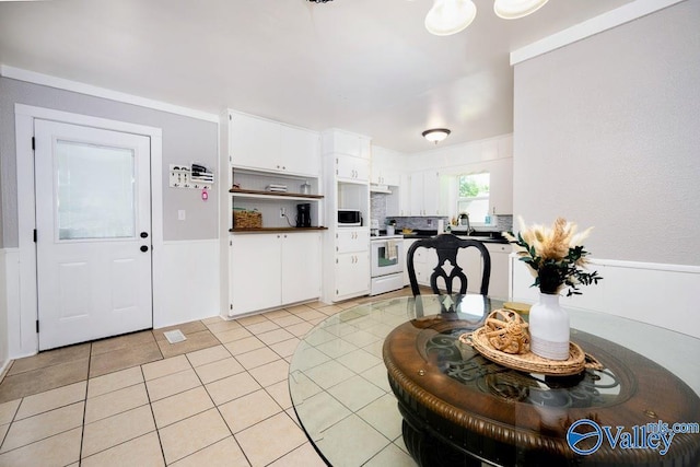 152 6th St W, Grant, AL 35747 - kitchen with white cabinetry, light tile patterned floors, open shelves, dark countertops, and white appliances