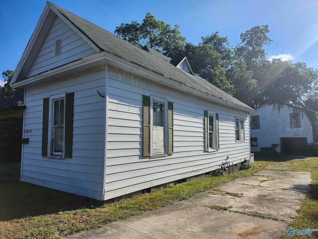 view of side of property with a patio