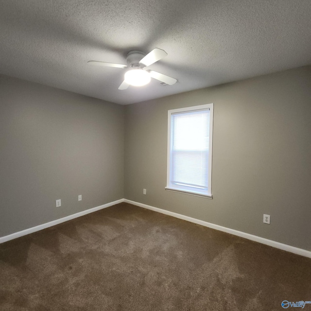 empty room with carpet flooring, ceiling fan, and a textured ceiling