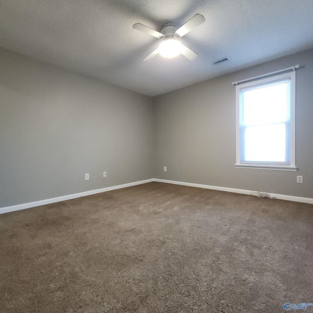 spare room featuring ceiling fan and carpet floors