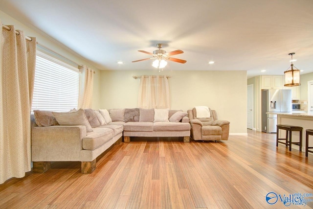 living area featuring a ceiling fan, light wood-style flooring, and recessed lighting