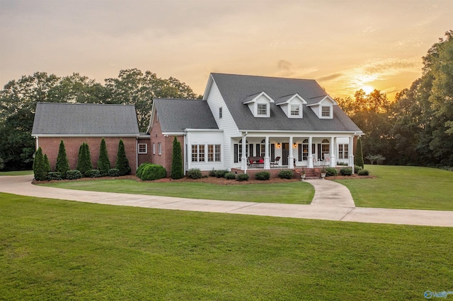 902 County Road 163, Centre, AL 35960 - cape cod-style house with covered porch, a yard, brick siding, and a shingled roof