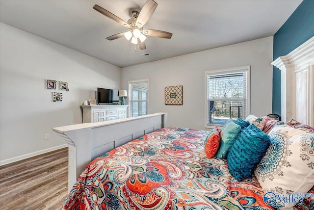 bedroom with ceiling fan and wood-type flooring