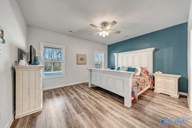 bedroom with ceiling fan and wood-type flooring