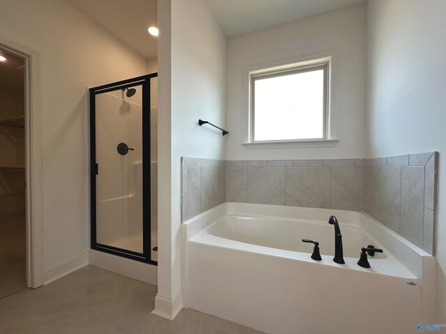 bathroom with independent shower and bath and tile patterned floors