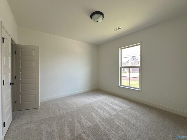 spare room with light colored carpet