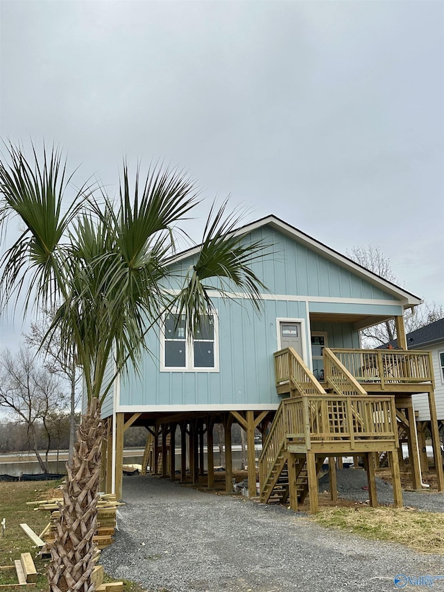 view of front of property with a carport and stairway