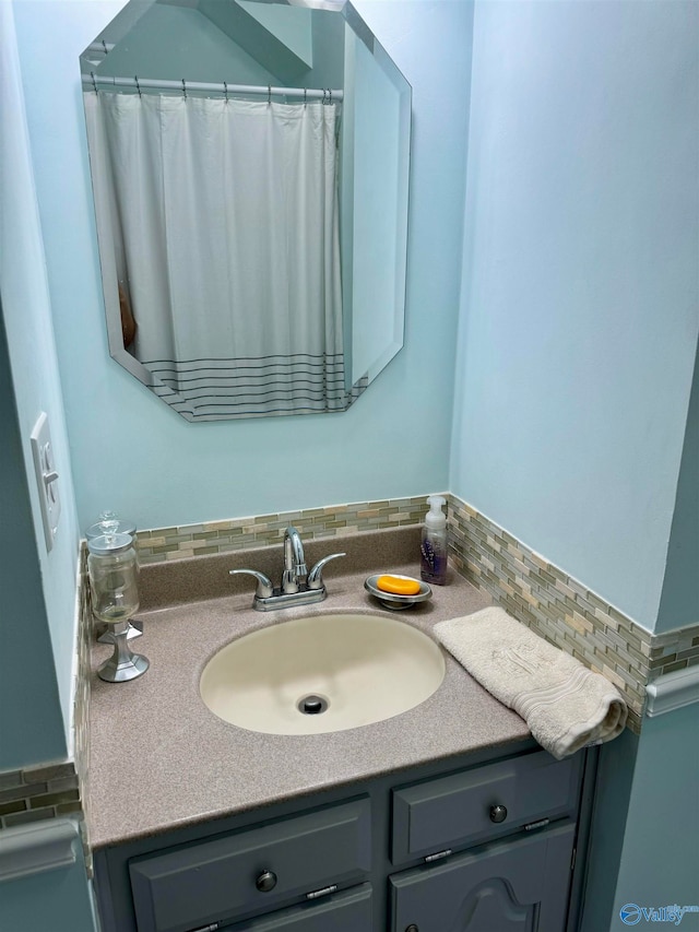 bathroom featuring vanity and tasteful backsplash