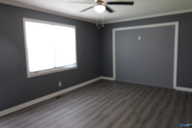 spare room with ceiling fan, a healthy amount of sunlight, and wood-type flooring