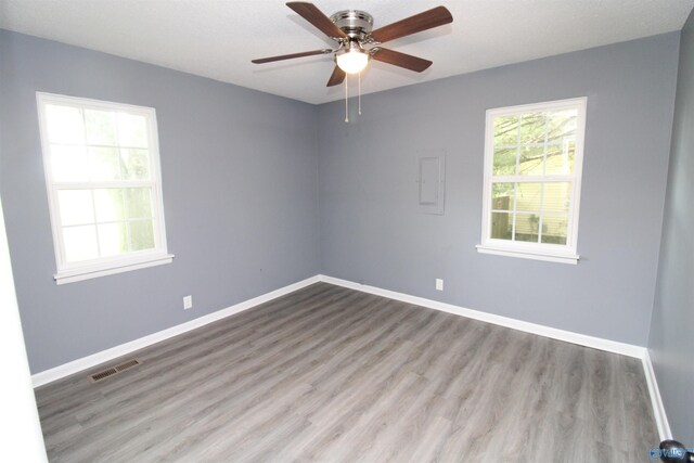 spare room featuring ceiling fan and hardwood / wood-style floors