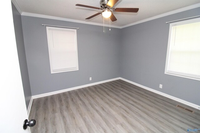 unfurnished room with hardwood / wood-style flooring, ornamental molding, and ceiling fan