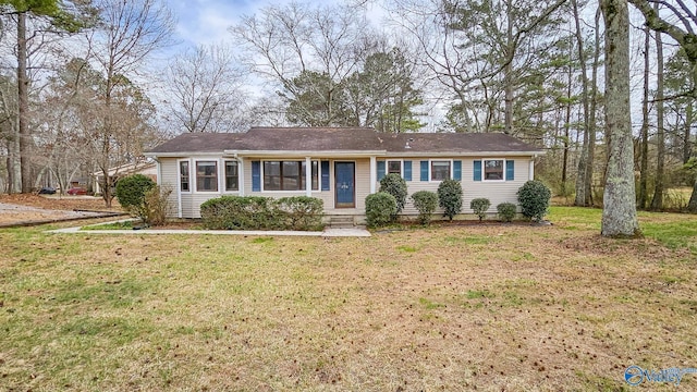 ranch-style home featuring a front yard