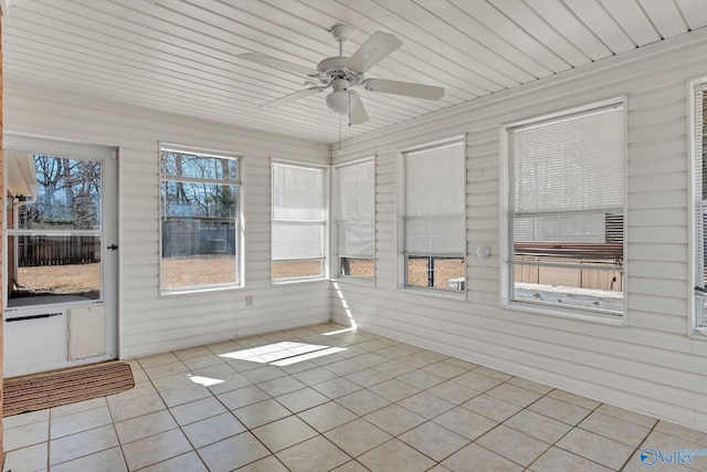 unfurnished sunroom featuring wood ceiling and ceiling fan