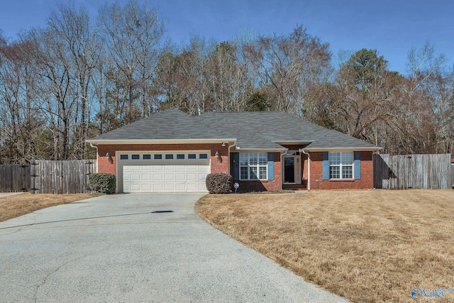 single story home featuring driveway, a garage, fence, a front lawn, and brick siding